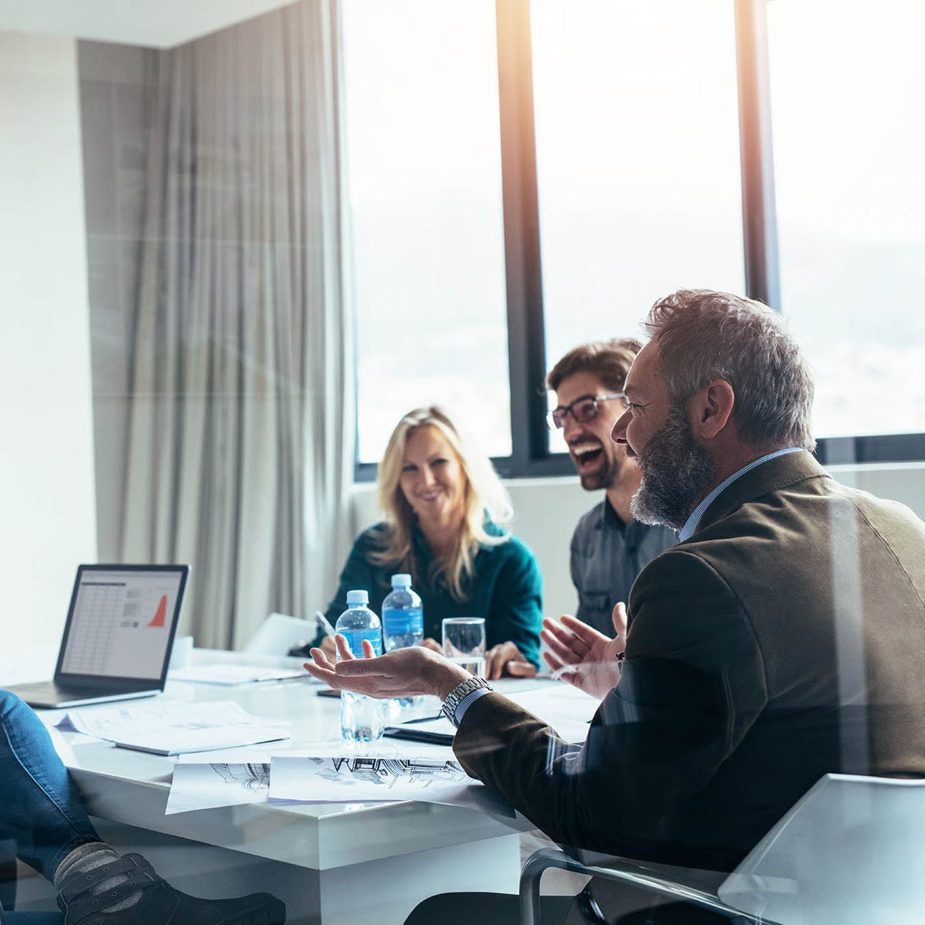 Business people having casual discussion during meeting Employee Advice: Supporting Your Retirement Planning